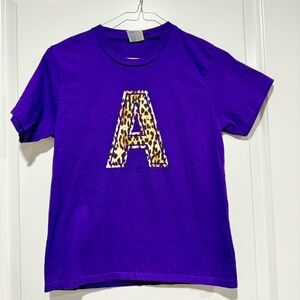 Girls purple T-shirt. Leopard print “A” initial. Like new. Worn 1x. Size Medium